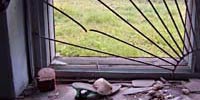 Window broken in schoolhouse, photo by Adam Dolnick